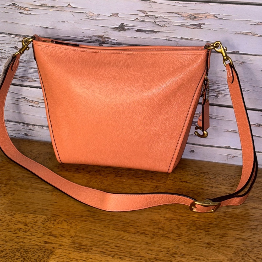 Coach light coral pebbled leather small dufflette bag.